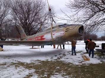 The Sarnia F-86 Sabre Golden Hawk is removed from Germain Park for restoration.