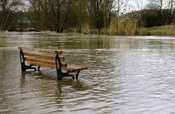 A bench surrounded by water. © Can Stock Photo / guffoto