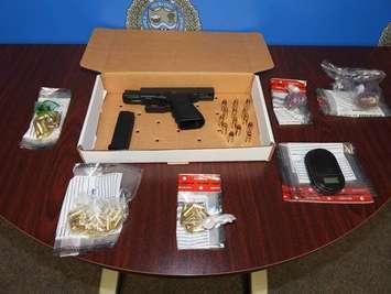 A firearm, ammunition, drugs and drug paraphernalia located in a Toronto man's vehicle.  May 2022.  (Photo by Sarnia Police Service)