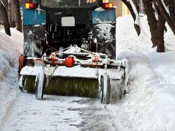 File photo of a sidewalk plow with a brush attachment courtest of © Can Stock Photo / reticent