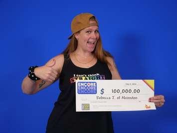 Rebecca Johnston of Alvinston with an Encore OLG cheque for $100,000. 4 July 2020. (Photo by OLG)