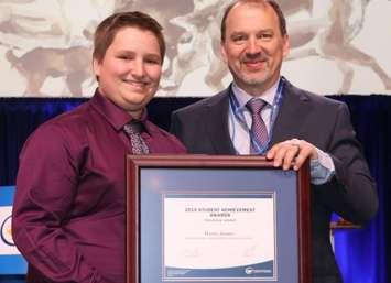 LCCVI student Harris Annett accepting a 2019 OSSTF/FEESO Student Achievement Award from President Harvey Bischof. March 2019. (Photo by Ontario Secondary School Teachers’ Federation)