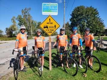 (From left to right) Jeff Burchill, Kathy Johnson, Ken MacAlpine, Paul Eastman and Pete Cobb of the Bluewater International Granfondo next to new "Share the Road" street signs.  October 2021.  (Photo submitted by B.I.G.)