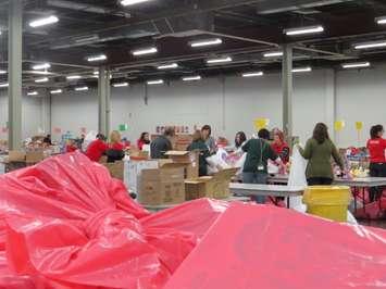 Volunteers work to pack Christmas hampers, December 14, 2015. Photo by Miranda Chant, BlackburnNews.com