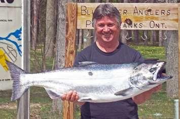 Jim Maxfield, of Forest , shows off his 23 lbs winning fish in the 2012 Bluewater Anglers salmon derby.