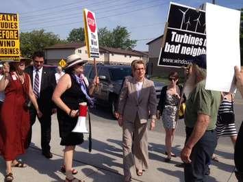 Ontario Premier Kathleen Wynne is greeted by wind turbine protesters at an event in Sarnia. May 31, 2013 BlackburnNews.com Photo)