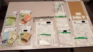Drugs and currency seized in Petrolia. February 2020. (Photo by Lambton OPP)