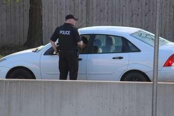 A Windsor police officer performs a traffic stop on Huron Church Rd., April 28, 2015. (Photo by Jason Viau)