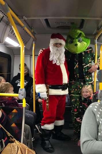 Santa Claus and the Grinch pose for a picture on the Celebration of Lights Bus Tour. December 2018. (Photo by the City of Sarnia)