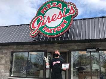 Mike Giresi showing off his 'MUNCH MADNESS Sarnia Lambton's Favourite Restaurant' trophy and plaque. April 2021. (Photo by Cool 106.3)