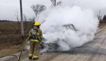 A firefighter dousing a fully involved pickup fire at Old Walnut Road and Oil Springs Line. January 14, 2019. (Photo by Brooke Fire via Twitter)