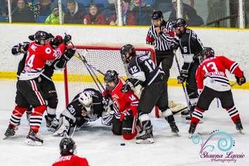 The Sarnia Legionnaires and Komoka Kings fight for the puck - Nov 8/19 (Photo courtesy of Shawna Lavoie)