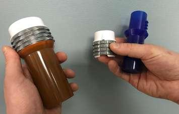 The two versions of the Safe RX locking prescription vials (LPVs). April 25, 2018. (Photo by Colin Gowdy, BlackburnNews)