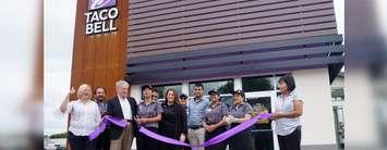 Taco Bell employees, Sarnia Mayor Mike Bradley, and Operations Manager Margaret Kertesz cut the ribbon at the grand opening of a Taco Bell on Indian Road. July 12, 2019. (BlackburnNews photo by Colin Gowdy)