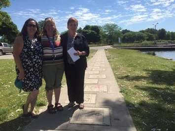 Survivor Lori Hare, Survivor and President of the Board for the Sexual Assault Survivor Centre Georgette Parsons and Sexual Assault Survivors Centre Executive Director Michelle Batty  gather at the Footsteps Tribute to Courage Walkway. June 21, 2016 (BlackburnNews.com file photo by Melanie Irwin)
