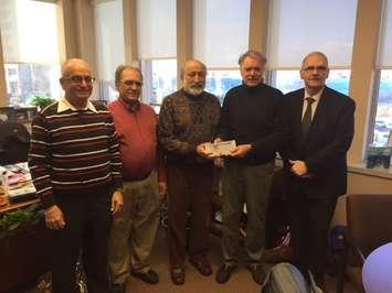 (Left to right) Ashvin Thakkar, Raj Barchha, Jaggi Singh present Sarnia Mayor Mike Bradley and DJ Robb Funeral Home's Tom Wolfe with donations to create an area to scatter cremated remains. December 7, 2017 (Photo by Melanie Irwin)