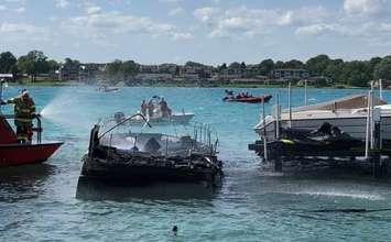 Firefighters battle a boat fire on the St. Clair River in St. Clair Township, September 3, 2020. (Photo courtesy of the St Clair Township Fire Department via Facebook)