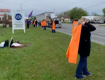 Striking VON Sarnia-Lambton employees don superhero capes on the picket lines. 5 May 2021. (Photo from LiUNA! Local 3000's Twitter page)