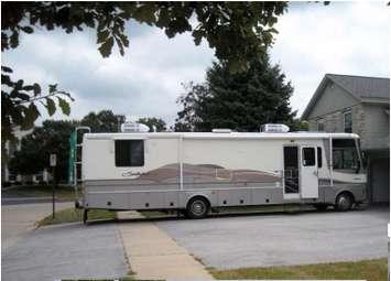 RV parked in a driveway obstructing sidewalk access. Photo courtesy of City of Sarnia presentation for June 22, 2015.
