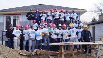 The Sarnia Sting helps with construction of Habitat for Humanity's latest build. December 2, 2014 (BlackburnNews.com photo by Jake Jeffrey)
