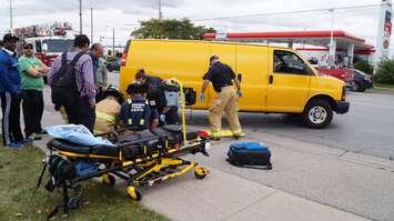 Fire and EMS helping bicyclist onto a stretcher after being involved in a collision with a van on London Rd. October 13, 2015 (BlackburnNews.com Photo by Briana Carnegie)