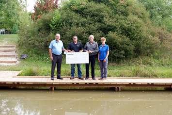 Enbridge representatives present the St. Clair Region Conservation Authority (SCRCA) with a $5,000 donation. The donation supported the construction of a pond edge boardwalk (pictured), a dedicated roadside walkway and a trail-stabilizing retaining wall (From left to right: Joe Faas, SCRCA Chair; Mark Ramsay, Field Supervisor, Enbridge; Ken Hall, Senior Advisor, Community Engagement, Enbridge; Sharon Nethercott, Conservation Education Coordinator)