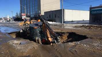 A backhoe sinks in Christina St. following a water main break in bitter cold - Jan 5/17 (Photo Courtesy of Brad Armstrong)