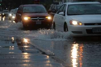 File photo of vehicles driving down a flooded road. (Photo by Blackburn News)