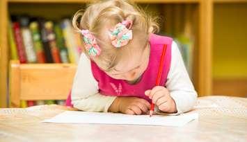 Cute child girl drawing with colourful pencils in preschool at the table in kindergarten
© Can Stock Photo / vitmark