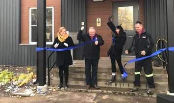 (L to R) Rebound Executive Director Carrie McEachran and Lambton County Warden Bill Weber help Tammy and Gary Vandenheuval cut the ribbon on their Lambton Supportive Transitional Housing facility. November 7, 2019 Photo by Melanie Irwin