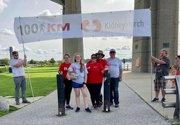 (From left to right) Alaina, Abby, Kim and Paul Wright, and Kim's father, Wayne Freer, celebrate the family's Kidney March trek under the Blue Water Bridge. 13 September 2020. (Photo from "Living on Love" Facebook page). 
