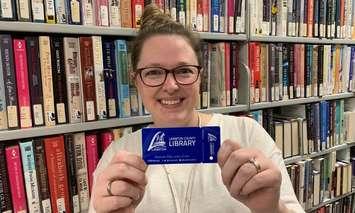 Staff at Lambton County Library show off newly designed library cards (Submitted photo)