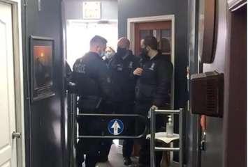 Bylaw officers at Sharky's Gym (Photo from Sharky's Athletic Club via Facebook)