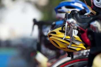 A cyclist helmet sitting on the bike waiting to be used at the transiation phase of the Triathlon. © Can Stock Photo Inc. / MrSegui