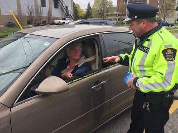 CN Police Constable Bruce Middleton hands motorists pamphlets on rail safety during a traffic enforcement activity on Front St. Tuesday, April 25, 2017 BlackburnNews.com photo by Melanie Irwin
