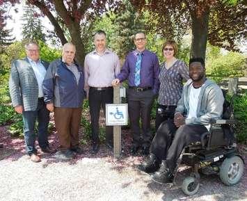 (Left to right) at the outdoor Charge Station at the Strangway Centre in Sarnia of:  Bill Weber, Warden, County of Lambton; Councillor Lonny Napper, Chair, County of Lambton Accessibility Advisory Committee; Brian White, Sarnia City Councillor and Member of the Sarnia Accessibility Advisory Committee; Dale Mosely, Accessibility Coordinator, City of Sarnia; Heather Allen, Supervisor, Program Review & Compliance, County of Lambton; Dan Edwards, Local Accessibility Advocate. (County of Lambton supplied photo.)