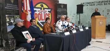 Trevor Miller, Jock Hill, Six Nations of the Grand River Band Council representative Sherri-Lyn Hill Pierce, Six Nations Acting Deputy Chief Darren Montour, OPP Dective Inspector Peter Liptrott, and OPP Constable Max Gomez at a news conference, November 15, 2018. Photo from OPP periscope video. 