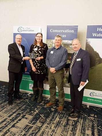 2022 SCRCA Vice Chair Pat Brown (far left) and 2022 Chair Mike Stark (far right) present Vivian and Chris Crump with an award from the St. Clair Region Conservation Authority (SCRCA). March 10, 2023. (Photo by SCRCA)