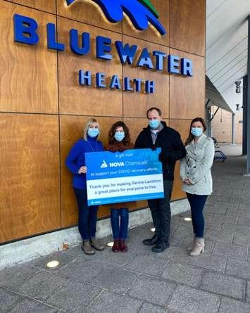 Bluewater Health Foundation Executive Director Kathy Alexander (second from right) accepts a donation toward local mental health services from NOVA Chemicals. December, 2021 (Image courtesy of NOVA Chemicals Twitter)