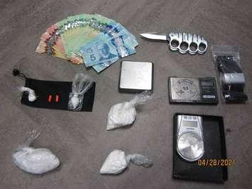 Drugs, cash and a weapon seized from an Exmouth St. residence - Apr 28/21 (Photo courtesy of Sarnia Police Service)