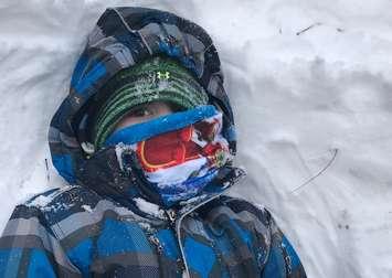 A little boy is bundled up for cold winter temperatures. Blackburn News file photo by Melanie Irwin
