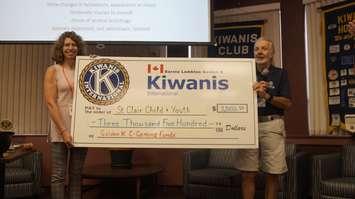 Susanne McLean from St. Clair Child & Youth Services accepting a donation from Sarnia-Lambton Kiwanis Club President Dick Felton. September 10, 2019. (BlackburnNews photo by Colin Gowdy)